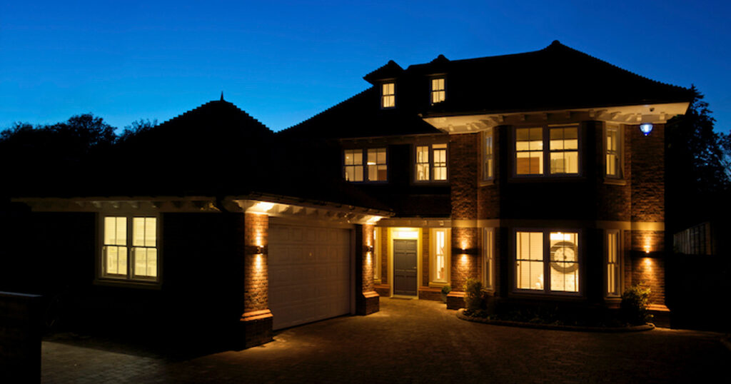 View of a home with lights on after sunset