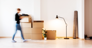 Person walking into new home with moving boxes